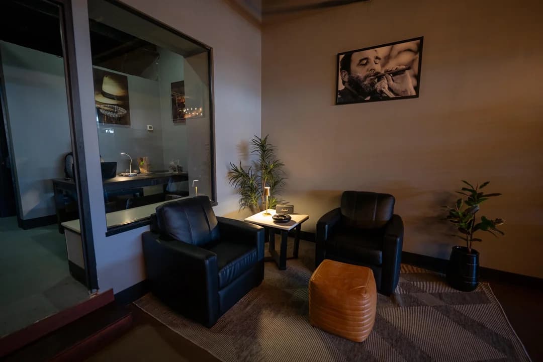 Intimate corner nook with two leather chairs and art