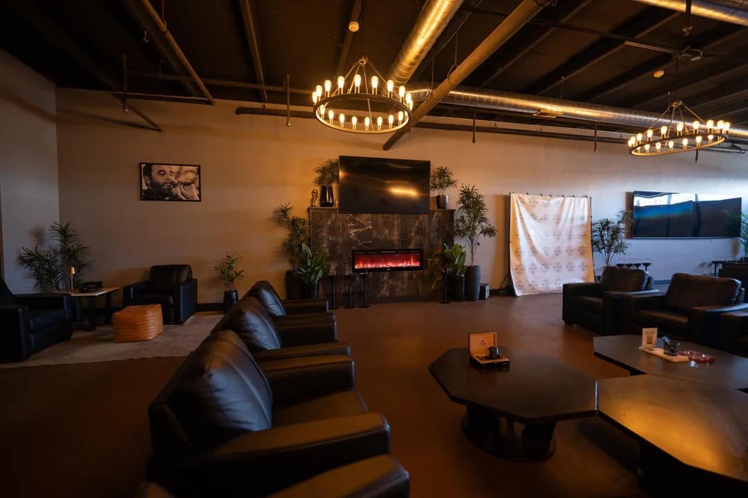 Fireside lounge area with elegant chandelier and leather seating