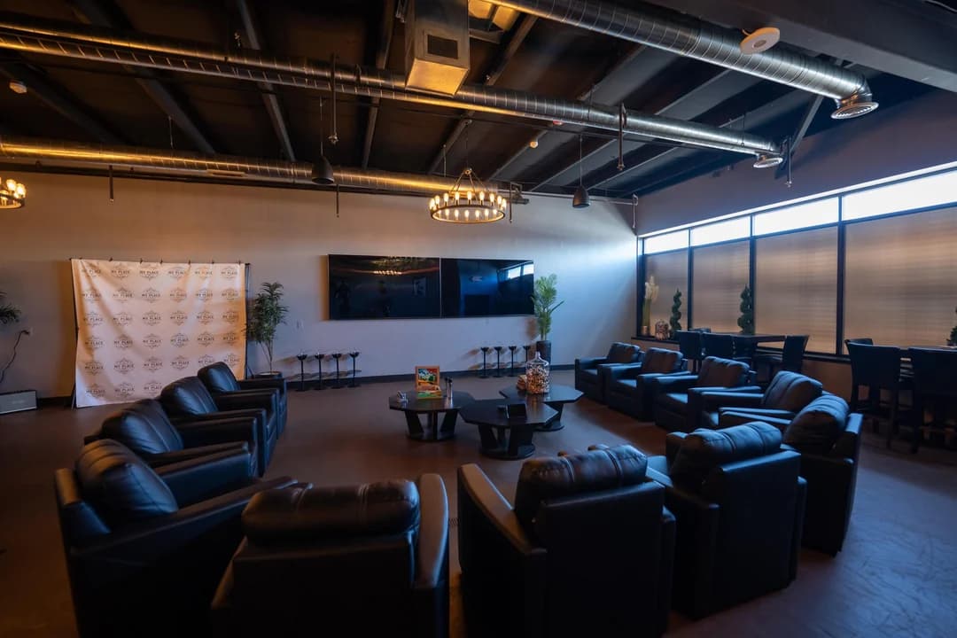 Lounge area with branded backdrop and comfortable seating