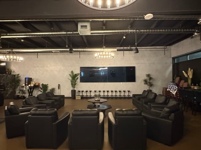 Main social area with large TV and leather seating